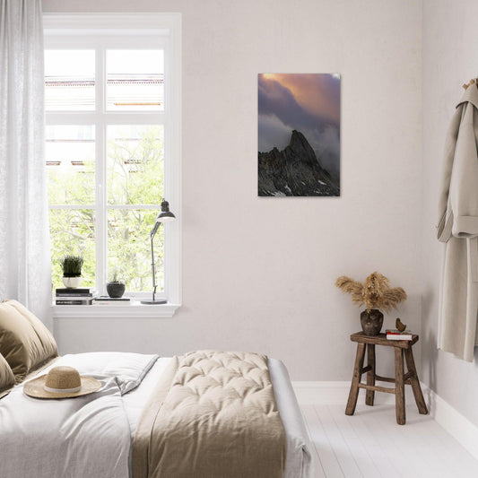 an extraordinary view of a grey stony marble mountain's sharp peak, enveloped by dense, multicolored clouds on a 50x75 cm vertical metal Poster - Linked Frame