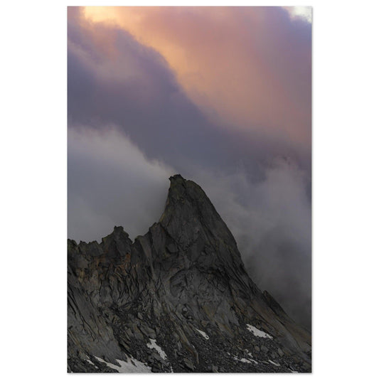 an extraordinary view of a grey stony marble mountain's sharp peak, enveloped by dense, multicolored clouds on a 50x75 cm vertical metal Poster - Linked Frame
